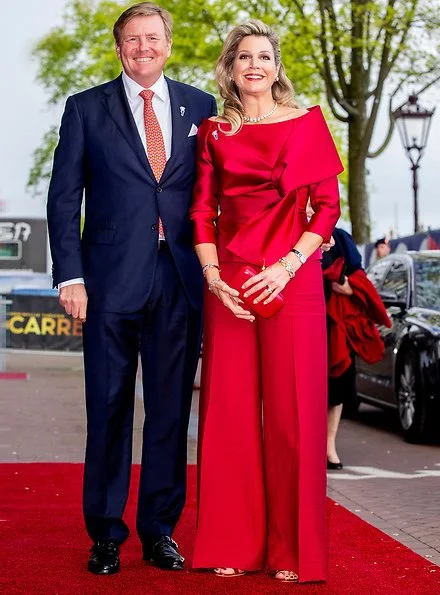 Queen Maxima wore a red top and red trousers. by Natan.Sarah's clutch bag. Carré Royal Theatre and around Amstel River