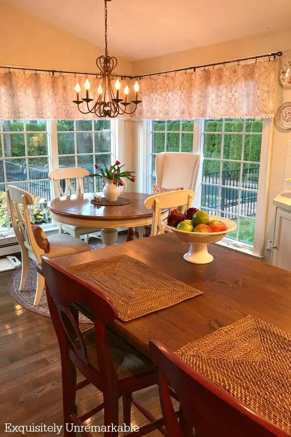 Charming Cottage Kitchen with white round table and wooden kitchen island