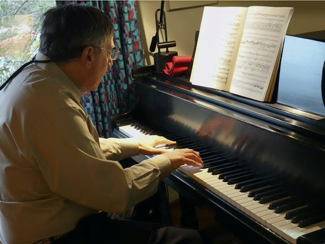 Dr. Newmark playing the piano.