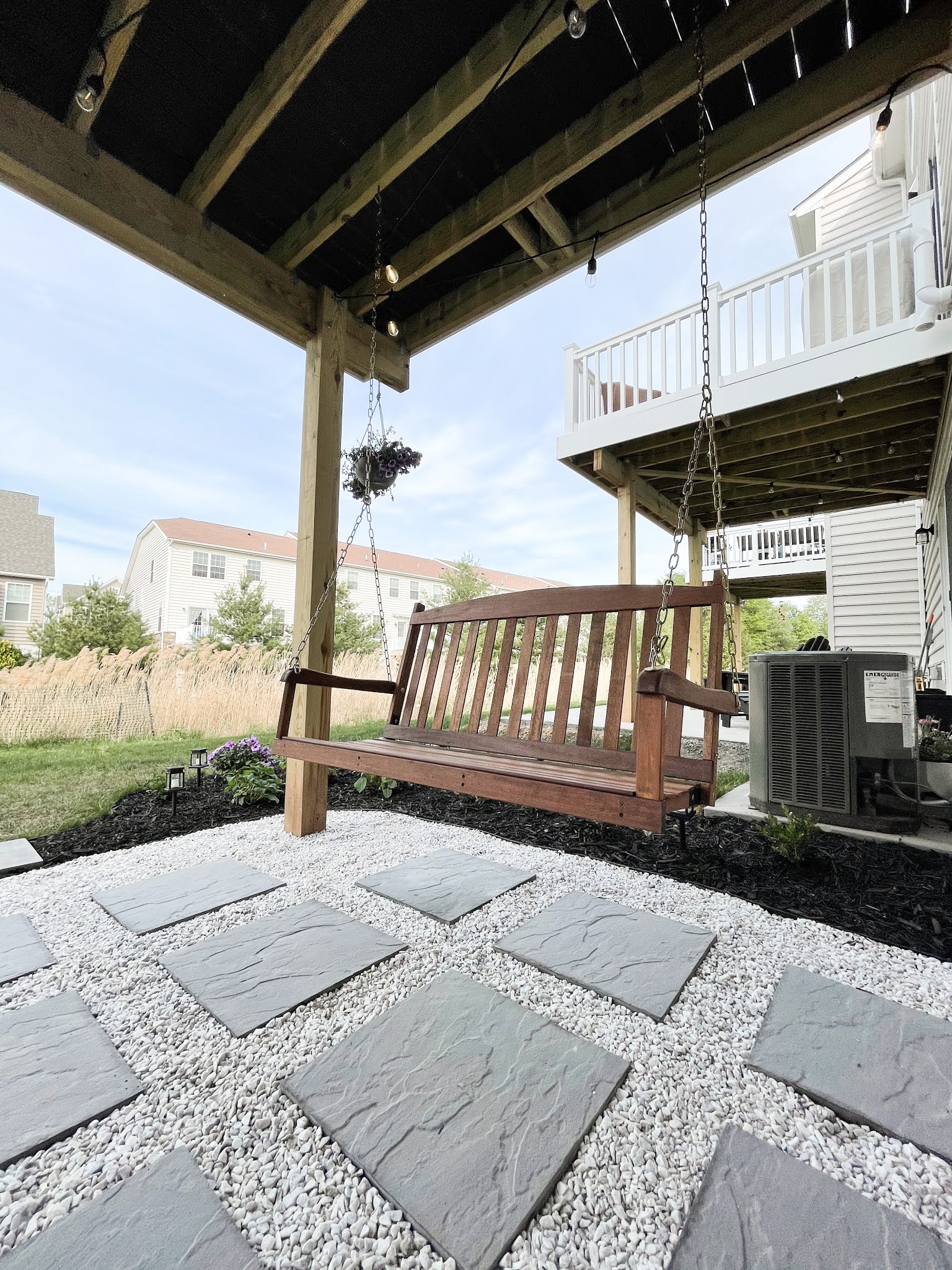 DIY PAVER AND MARBLE GRAVEL PATIO WITH MULCH BEDS & PORCH SWINGS A