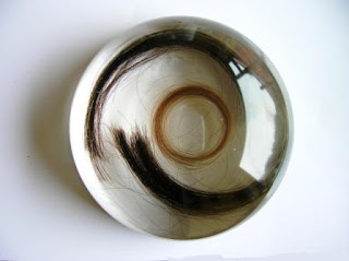 Paperweight containing several locks of hair