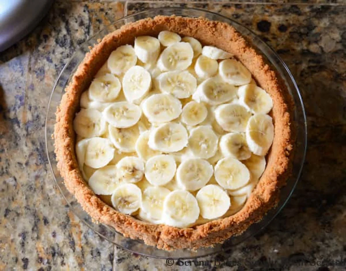 Layers of Bananas for Banana Pudding Cheesecake in a Graham Cracker Crust from Serena Bakes Simply From Scratch.