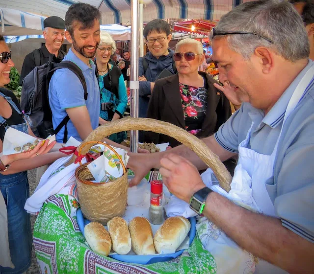 Sicily street food - vendor serviing a 'A Frittula