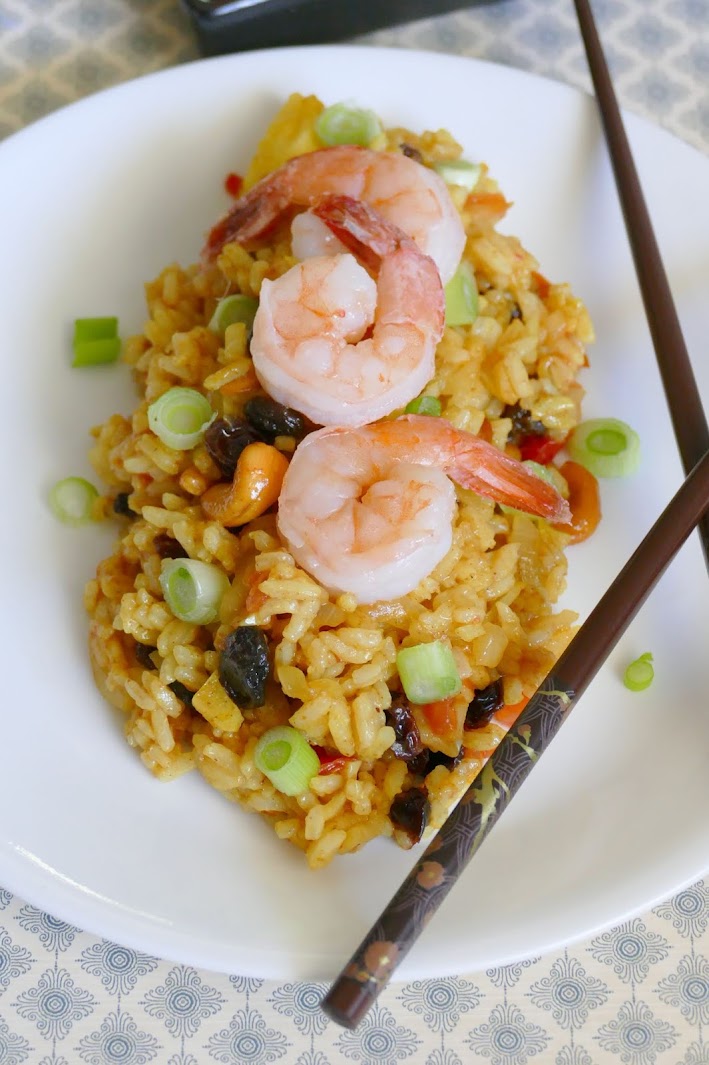 This easy 30 minute Shrimp Pineapple Fried Rice is delicious and such a great way to use leftover rice! This Thai inspired recipe gets it's flavors from pineapple, nuts, curry and raisins, along with vegetables and shrimp. Also great with chicken and so much better than takeout!