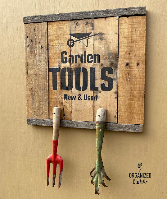 Photo of a pallet sign stenciled with a garden tools stencil