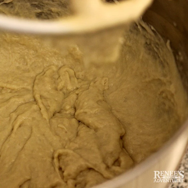 Overhead process image of dough in mixer bowl beginning to form forApple Cinnamon Rolls with Maple Frosting by Renee's Kitchen Adventures