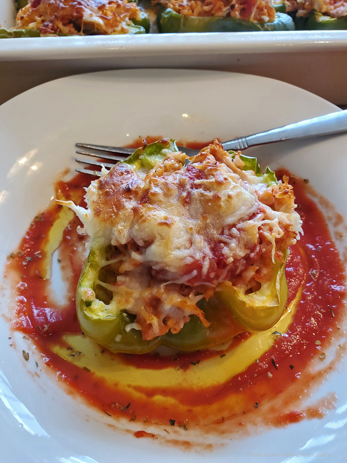 this is a chicken stuffed bell pepper with sauce 