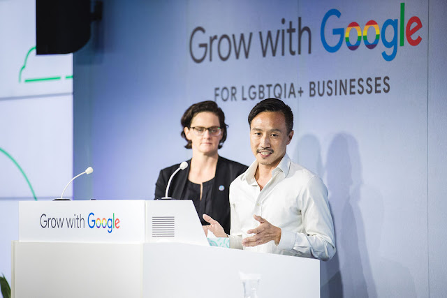 Kate Wickett and Adrian Phoon stand at a podium. Behind them a wall reads "Grow with Google for LGBTQIA+ businesses"