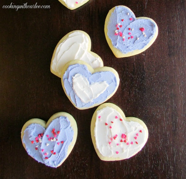 These sour cream cookies are a long time family favorite recipe. They are soft, flavorful and perfect as drop cookies or cut outs. heart shaped sour cream cookies with buttercream frosting