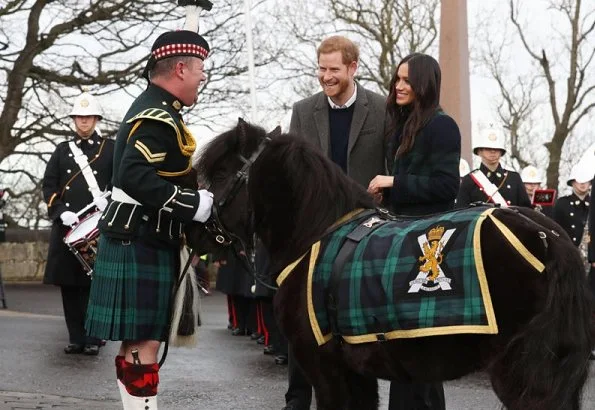 Meghan Markle wore a double-breasted tartan wool-blend coat by Burberry during Edinburgh visit. Meghan carried Strathberry Mini crossbody bag