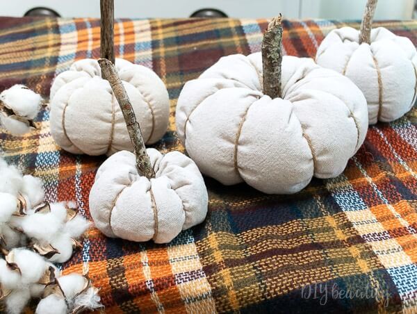 drop cloth pumpkins with stick stems, cotton and plaid throw