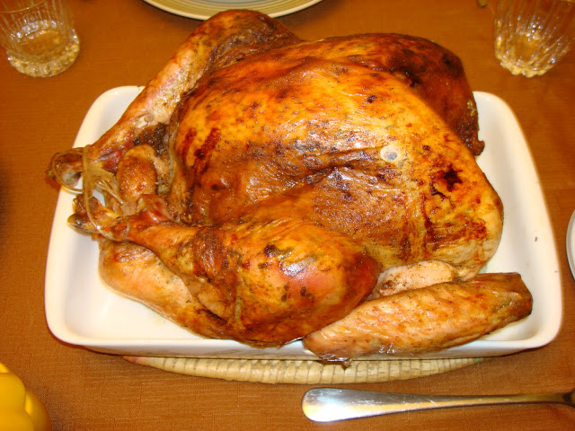 ROASTED TURKEY WITH FRESH HERBS PORTIONS: 10 INGREDIENTS 1 (13 lb.) whole turkey 1 tbsp. butter 1 tbsp. olive oil 2 garlic cloves 2 tbsp. chopped parsley 2 tsp. fresh oregano or 1 tsp dried 1 onion chopped ¼ tsp. ground pepper 2 tsp. salt PREPARATION Use a blender and make a paste with the ingredients. Wash the turkey with cold water inside and outside, and dry it with paper towel. With the tips of your fingers separate the skin of the breast and turkey legs. Use the seasoning paste under the turkey skin of the breast and legs. OUTSIDE SKIN SEASONING 2 tbsp. melted butter 1 tsp. salt ¼ tsp. pepper ½ tsp. paprika METHOD Mix the butter with the rest of the ingredients and brush it on top of the skin.  Bend the wings underneath the turkey. Tight together the turkey legs with twine. GRAVY INGREDIENTS 1 cup merlot wine 2 cups chicken broth, turkey broth or chicken bouillon dissolved in water. ¼ cup tomato sauce 1 tbsp. butter 1 tbsp. flour PREPARATION  In a baking pan big enough to hold the turkey pour in the wine, broth, tomato sauce and mix well. Place a griddle or rack on the baking pan and turkey on top. Preheat the oven at 325°F / 163°C. Cook the turkey for about 3 hours or until it has 170°F / 77°C internal temperature. If the turkey is browning too much you can cover it with aluminum foil.  Do not let the juices to dry out, add more liquid if need it. Baste the turkey about every 20 minutes.   Once the turkey is cooked, place it in a platter and let it rest for about 20 minutes before carving. It will keep the juices in. Scrape the bottom of the pan with the juices, use a fat separator and set aside. Heat a small pot and melt butter. Add the flour and slightly brown it. Add liquid and it will thicken, let it cook slowly for about 7 minutes. Add water if need to thin it.  NOTE: you can use other herbs, like tarragon, rosemary, sage, thyme leaves, whichever herb you prefer.