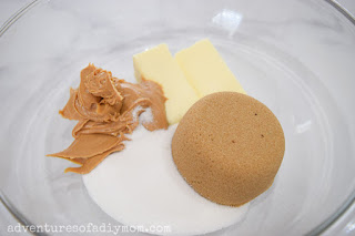 sugars and butters in a bowl to make peanut butter blossoms