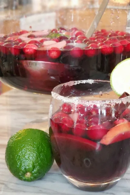 glass of sangria in front of bowl of sangria