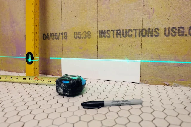 using laser level to start wall tile at floor