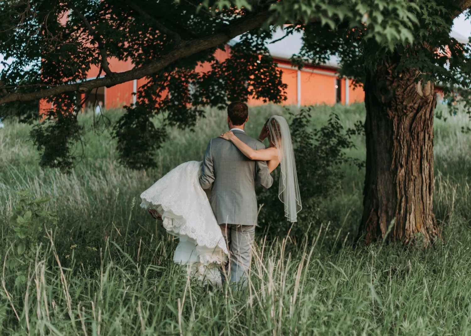 couple in a wedding clothes posing in a field