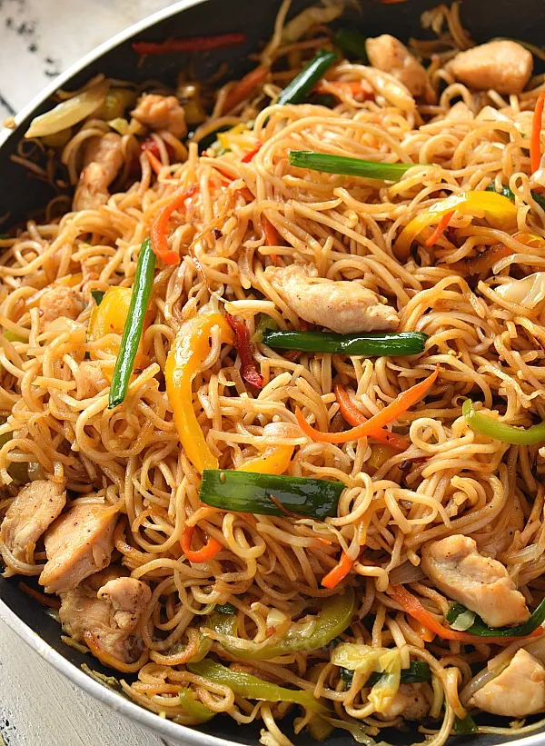 close look of pan with deliciouschinese chow mein with chicken and vegetables and chow mein sauce
