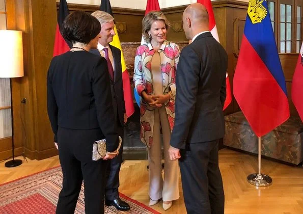 Queen Mathilde wore Diane von Furstenberg Vivanette gown, Giorgio Armani duster coat at Hotel Waldhaus in Sils Maria