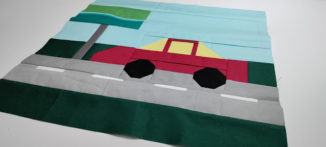 Road trip quilt block with car and billboard