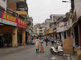 woman pushing a baby stroller on Jiefang East Road in Yunfu
