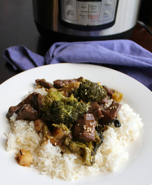 Make a take out inspired dinner in your slow cooker or instant pot. We love making this with venison backstrap, but but beef works well too! close plate of backstrap and broccoli served on rice with instant pot in background
