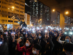 people holding their mobile phones with lights at a protest in Lai Chi Kok, Hong Kong