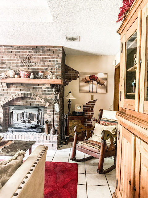 rustic neutral living room with red rug