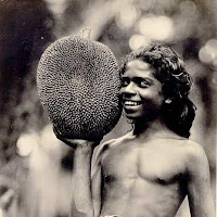 Vintage picture of a smiling Ceylonian man with a jackfruit.