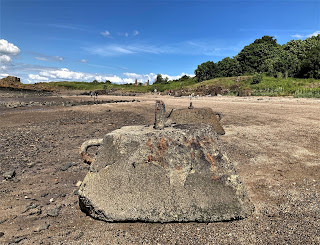 Two large concrete blocks on the beach that were anchor points for an anti-submarine net.  Photo by Kevin Nosferatu for the Skulferatu Project