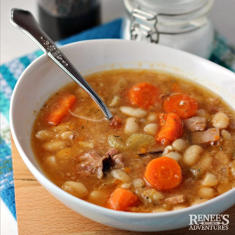 Ham and Bean soup in white bowl with spoon