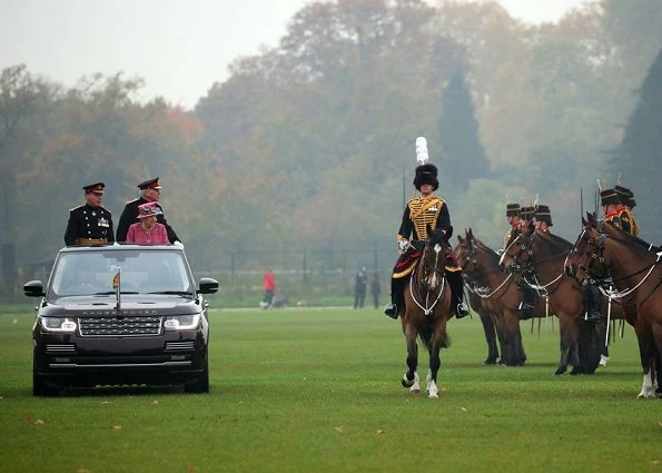 Britain's Queen Elizabeth II at the Hyde Park. Style of Queen Elizabeth, Fashion pink coat, dress, and clutch bag