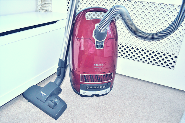 Miele Complete C3 Pure Red Bagged Cylinder Vacuum Cleaner upright with floor head and telescopic tube attached