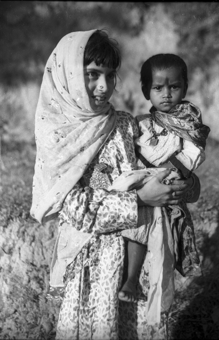 Young girl from Afghanistan carrying a small Hindu child from the ...