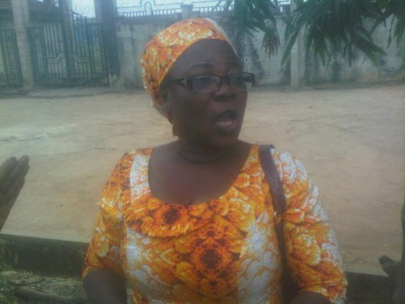 woman scooping fuel from nnpc pipeline from home