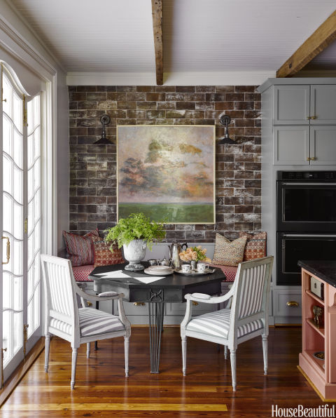 Ken Fulk cozy dining nook banquette exposed brick New Orleans