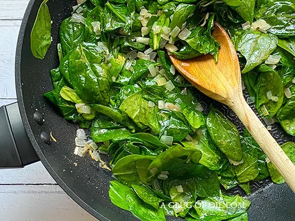 Spinach and shallots in a frying pan