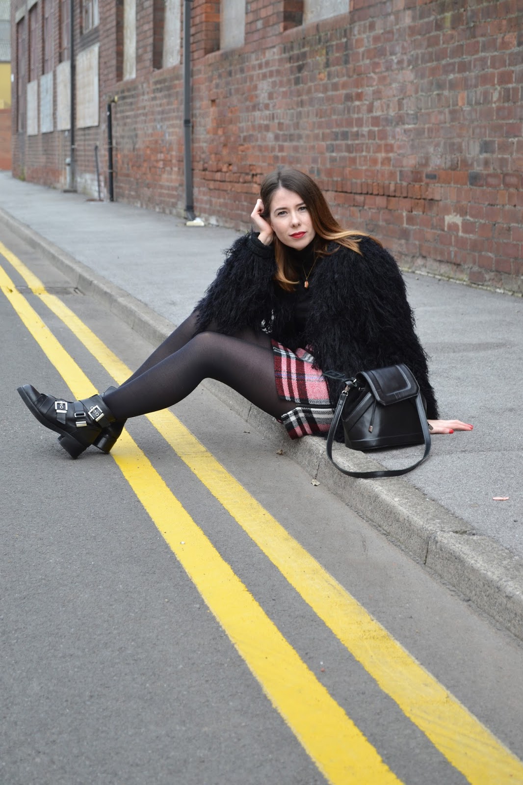 womens affordable highstreet fashion blog featuring British street style. Black polo neck. Topshop tartan skirt. Leather black buckle boots from Kurt Geiger. Black shabby jacket. Hollies closet
