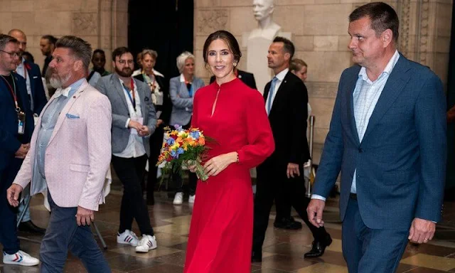 Crown Princess Mary wore an Armonia red silk georgette dress by Raquel Diniz. Gianvito Rossi. Rebekka Notkin carved gold earrings