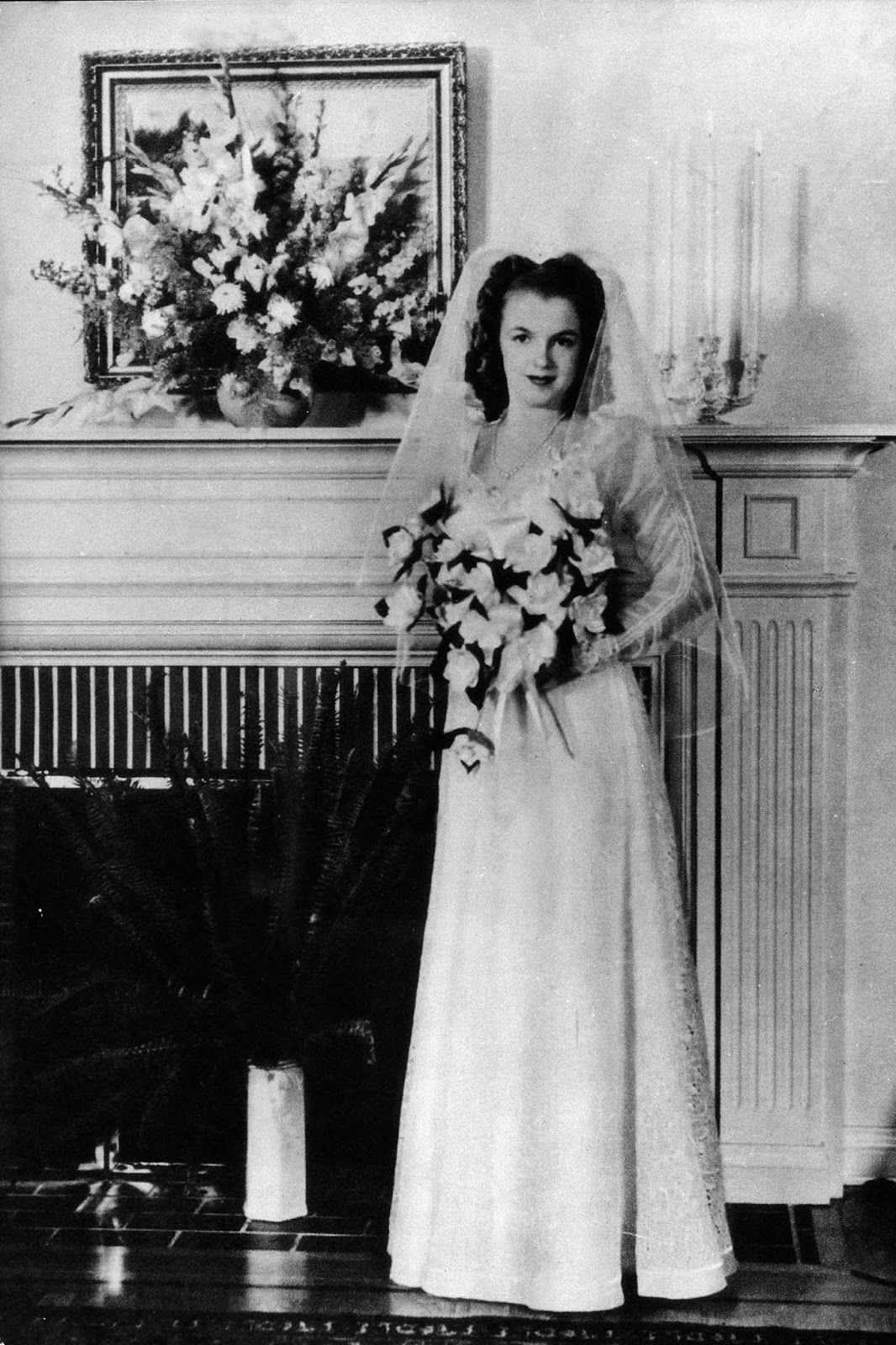 The wedding was officiated by a minister, Norma Jeane wore an embroidered lace wedding dress with long sleeves and veil.