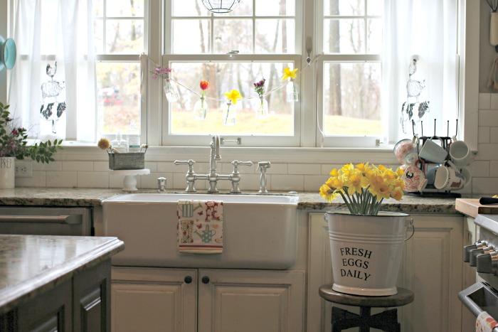 White kitchen with farmhouse sink and spring decor - www.goldenboysandme.com