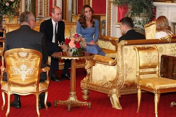 Kate Middleton wore a blue v-neck belted bespoke dress from Emilia Wickstead, and her praline Gianvito Rossi pumps. First Lady Olena Zelenska