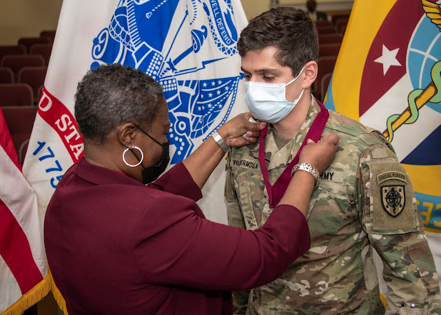 Dr. Althea Dixon-Green presents Army 2nd Lt. Alex Villahermosa with an award