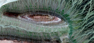 Allegory velociraptor green eye, green iridescence, concentric inner geode, photo of abstract landscapes of deserts of Africa from the air, Munimara Collection of Abstract Naturalism Allegory velociraptor green eye, green iridescence, concentric inner geode, photo of abstract landscapes of deserts of Africa from the air