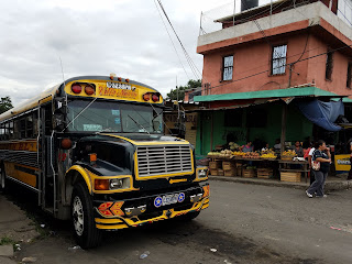 chicken bus and produce stand in guatemala