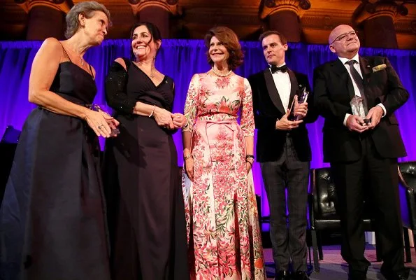 Princess Madeleine wore Giambatista ValliI floral print gown, and she carried Valentino Pink Rockstud clutch bag, Silvia wore a floral dress