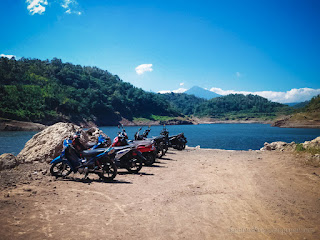 Angler Motorcycles Parked By The Lake Water Of Titab Ularan Dam On A Sunny Day North Bali Indonesia