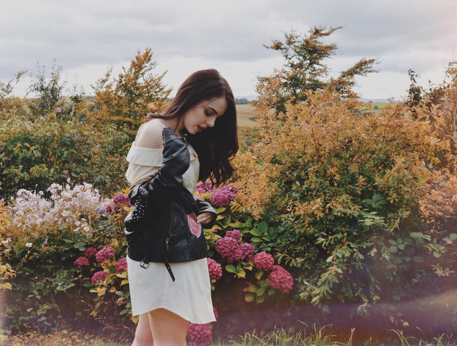 girl in field with leather jacket