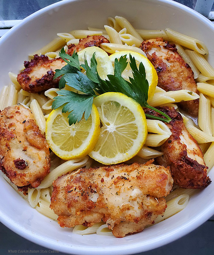 this is a bowl of penne pasta and lemons with fried chicken