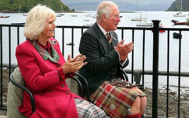 Duchess wore a waist-cinching red coat with a tartan lapel and tan heels. Camilla added a sapphire and diamond brooch
