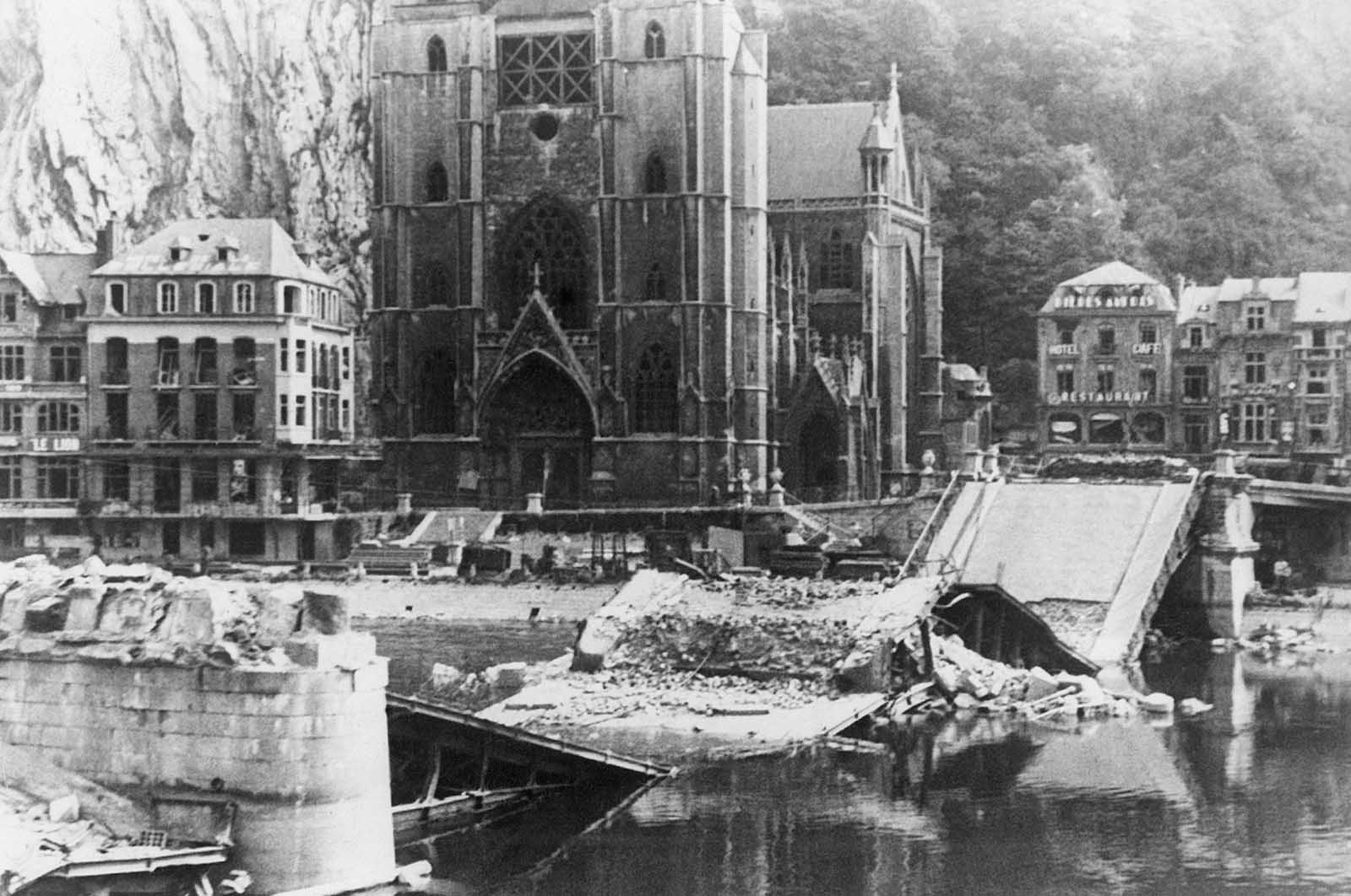 Belgians blasted this bridge across the Meuse River in the town of Dinant, Belgium, but shortly, a wooden bridge built by German sappers was standing next to the ruins, on June 20, 1940.